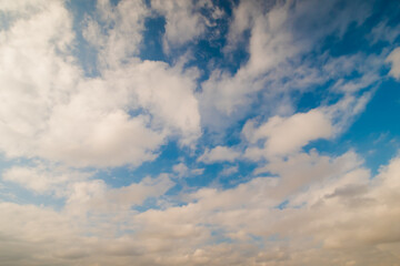 View of white clouds in the blue sky. Daylight, cloudy day. Freedom, cloudscape, nature and peaceful concept