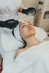 A girl at a cosmetologist does cosmetic procedures. Skin cleansing