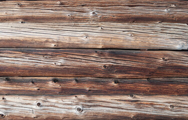 Texture of old weathered cracked wooden log wall