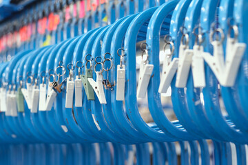 A metal roller rail in a textile factory industrial setting. Metal oil hangers on metal rollers....