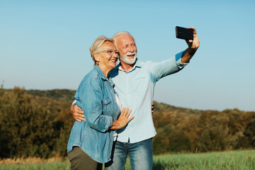 woman man outdoor senior couple happy lifestyle retirement together smiling love selfie camera...