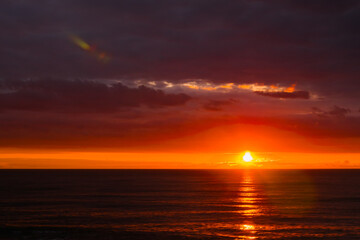 Amazing dramatic sunset sky with clouds over the Black Sea surface in the evening. Summer, cloudscape and nature concept