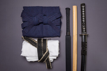 The concept of minimalism in traditional martial arts. Clothes and training weapons for fencing on...