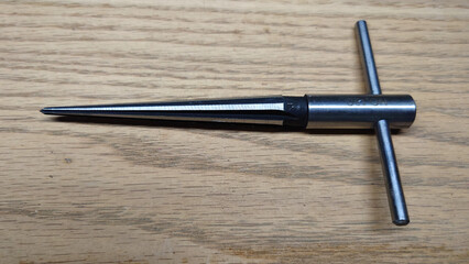 tapered reamer to remove burrs from drilled or bored holes in metal