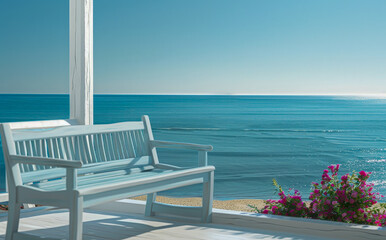 A blue bench is on a wooden deck overlooking the ocean