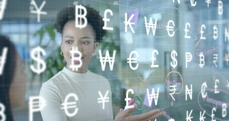 Animation of international currency symbols over diverse female colleagues brainstorming at office - Powered by Adobe