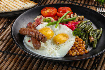 Traditional Engrlish breakfast with egg  and sausages