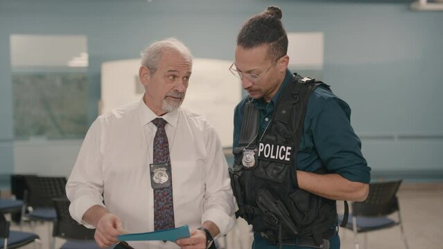 Police chief briefing officer on a case file