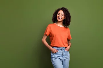 Fotobehang Lengtemeter Photo of charming cute woman wear orange t-shirt smiling empty space isolated green color background