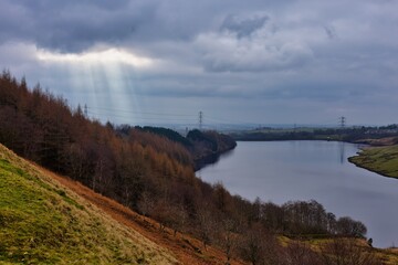 landscape with lake and mountains and sun rays