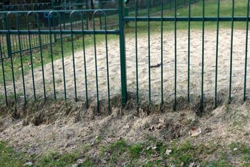 Sand flowing behind metal fences