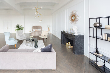 Modern luxury stylish apartment interior in pastel colors. a very bright room with huge windows filled with daylight. white walls, wooden parquet floors and a dark marble fireplace