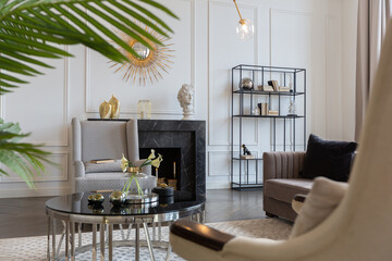 Modern luxury stylish apartment interior in pastel colors. a very bright room with huge windows filled with daylight. white walls, wooden parquet floors and a dark marble fireplace