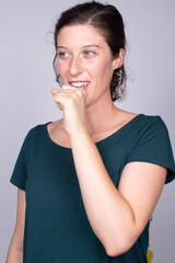 young woman pondering with a contemplative gesture