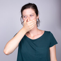 person with hand on cheek indicating severe toothache or dental pain