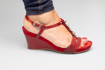 Elegant Red Wedge Sandal on a Woman's Foot