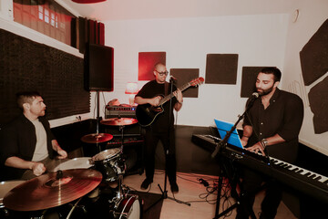 Men in music band performing with various instruments