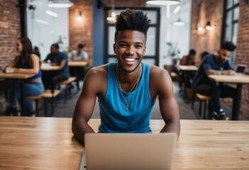 An engaged student wearing a sleeveless top focuses on his laptop in a cafe. His upbeat smile and active stance suggest effective studying and a lively learning environment. - obrazy, fototapety, plakaty