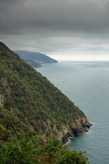 The green coast of Cinque Terre with cloudy sky, Liguria,  Italy