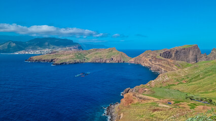 Panoramic view of coastal village Canical at majestic Atlantic Ocean coastline seen from Ponta de Sao Lourenco peninsula, Madeira island, Portugal, Europe. Hiking trail along steep rocky rugged cliffs