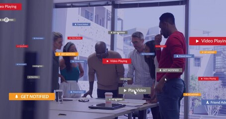 Animation of social media icons with texts over diverse colleagues having meeting in office - Powered by Adobe