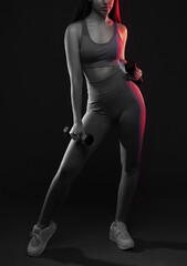 Slim, bodybuilder girl, lifts heavy dumbbell in the gym. Sports concept, fat burning and a healthy...