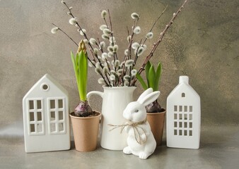 Easter composition on a brown concrete background, on the table there is a vase with willow...