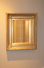 Luxury vintage mirror with gold frame on the wal