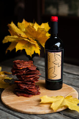 The bottle of wine and dried meat