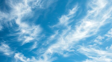 Wispy white clouds against a vivid blue sky. Perfect for a relaxing daydream or as a backdrop for your next project. - obrazy, fototapety, plakaty