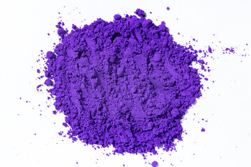 a bunch of dry natural purple pigment on a white background macro