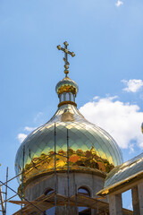 Construction of the Orthodox Church. Golden domes with Orthodox crosses against the blue sky - 757535084