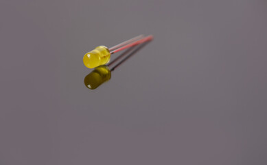 Isolated single yellow Light Emitting Diode (led) on the gray.
