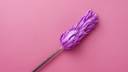 A beautiful artistic paintbrush with purple bristles. The bristles are made of thick oil paint and...