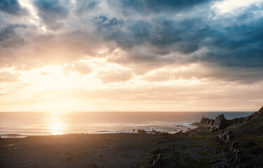 Dramatic scene with big rocks, sea, sunbeam and sundown - 757543294