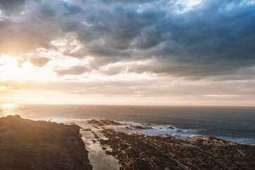 Dramatic scene with big rocks, sea, sunbeam and sundown - 757543295