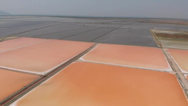 Aerial view above red Salt production pools in Albania - tracking, drone shot