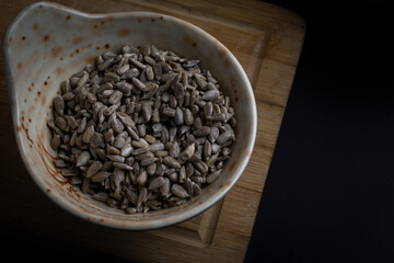 Peeled sunflower seeds in small bowl,top view