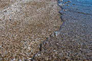 Crystal clear sea water texture with glare from the sun, wallpaper