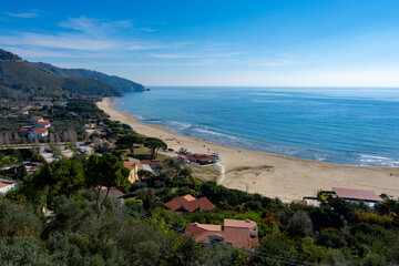 View on sandy beach from hilly medieval small touristic coastal town Sperlonga and sea shore, Latina, Italy