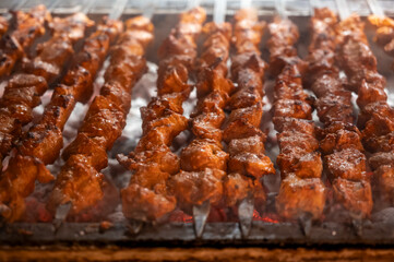 Turkish mixed grill meat, chicken wings, lamb, beef shashlik, kebab cooking on charcoal grill in restaurant