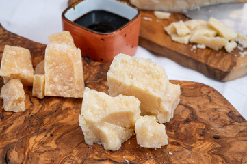 Tasting of 24 and 48 months aged Italian parmesan hard cheese from Parmigiano-Reggiano, Italy and balsamico vinegar from Modena