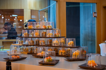 Japanese cuisine, modern restaurant with sushi, sashimi, other Japanese dishes served on moving...