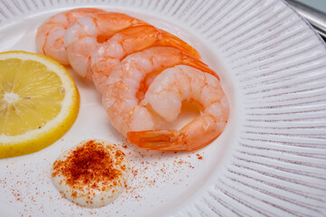 Catch of the day, fresh cooked shrimps served with lemon and garlic sauce in seafood restaurant