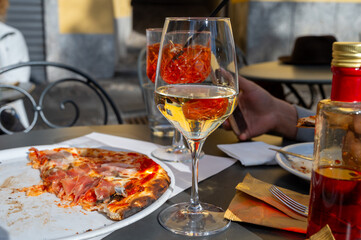 Glass of cold dry white wine served outdoor in cafe in Bellagio, Como lake, Italy