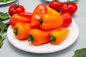 Fresh red, orange, and yellow sweet bell paprika close up