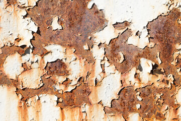 Rusty metal texture. Corrosion background. White peeling paint. Grunge rust on metal. Cracked paint pattern.