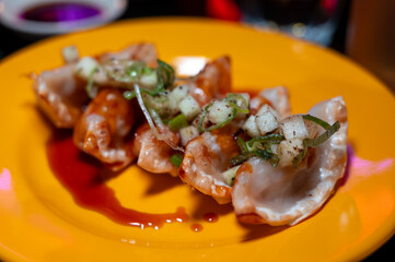 Tasty asian food, homemade deep fried chicken gyoza dumplings close up in Japanese bar