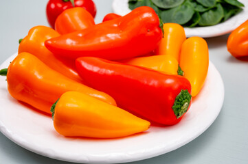Fresh red, orange, and yellow sweet bell paprika close up
