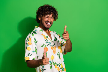 Photo of excited funky arabian man wear print shirt winking showing two fingers you empty space...
